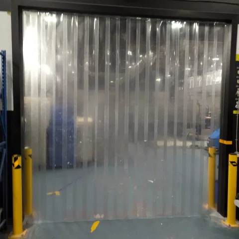 Clear PVC strip curtain installed in a warehouse dock door by JB Equipment