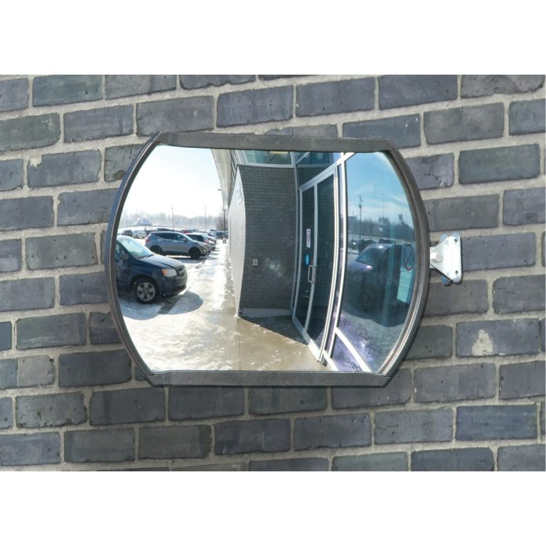 Roundtangular convex mirror mounted on a brick wall