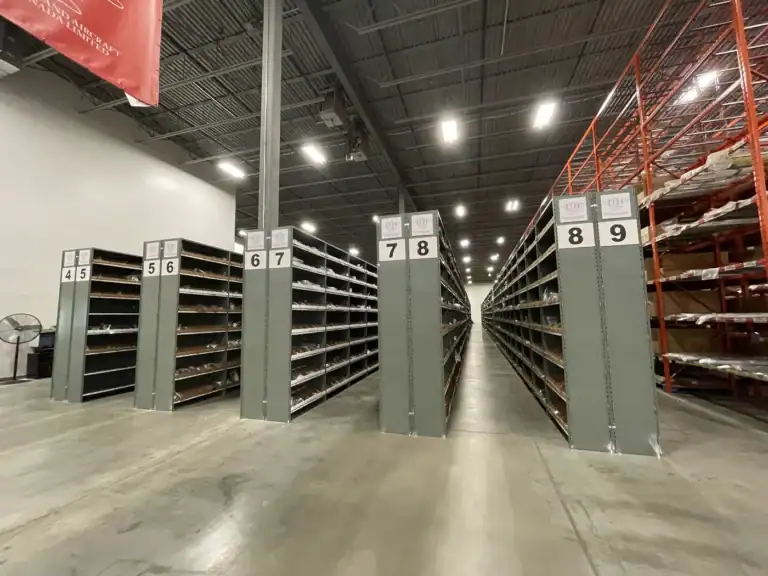 Rows of System 200 steel shelving with solid side panels in a warehouse