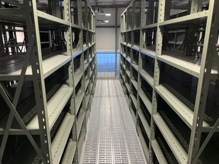 Upper walkway between rows of steel shelving