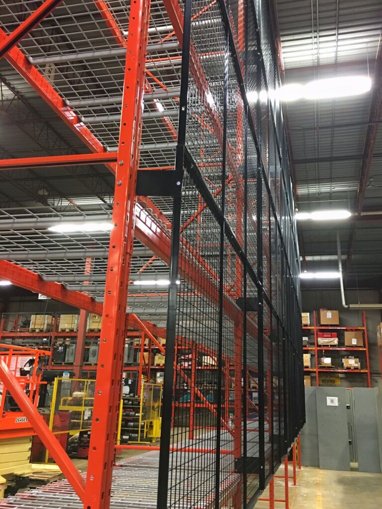 Black wire mesh panels on the back of pallet racking
