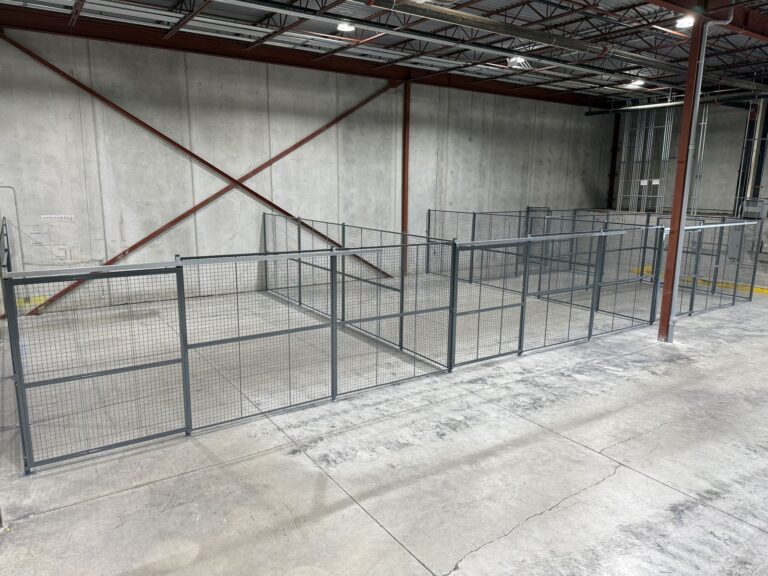 Wire mesh partitions creating a secure area in a warehouse