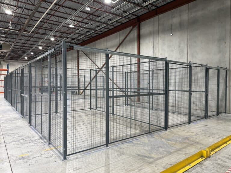 Long run of wire mesh partition storage cages in a warehouse