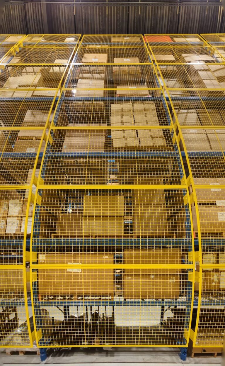 Wire mesh rack guards on both sides of an aisle
