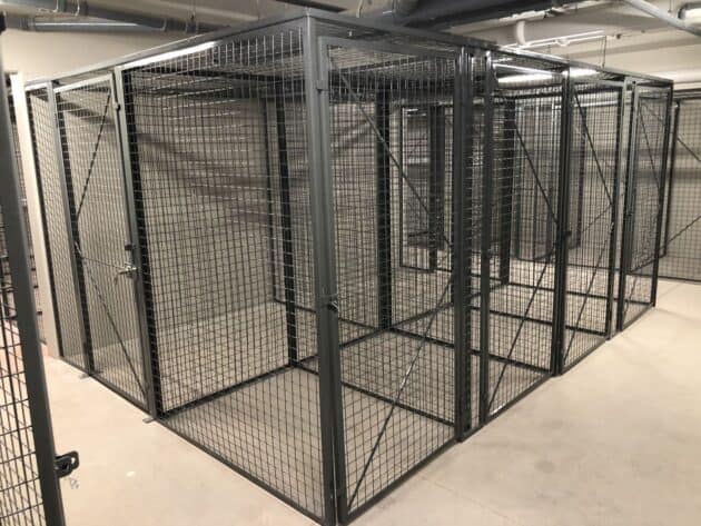 Row of framed wire mesh storage lockers with doors