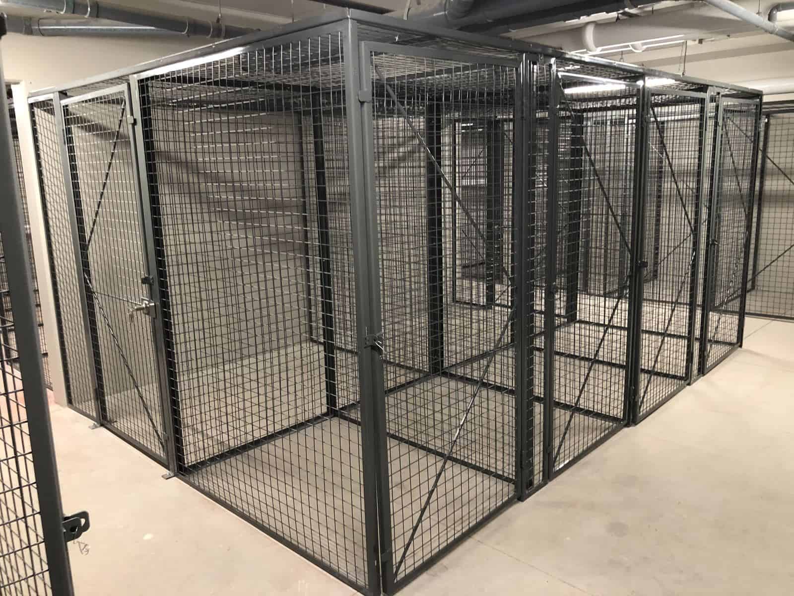 Row of framed wire mesh storage lockers with doors